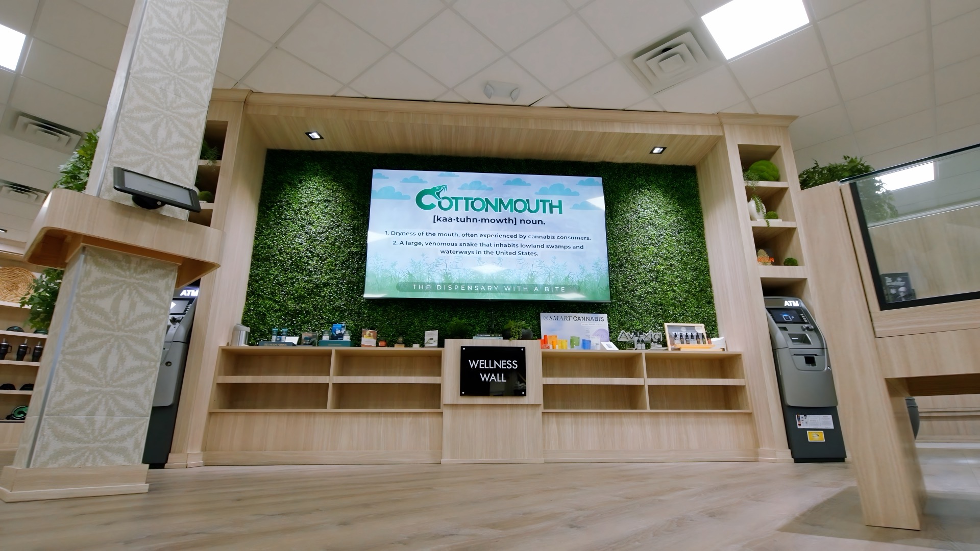 Cottonmouth Dispensary wellness wall with curated products